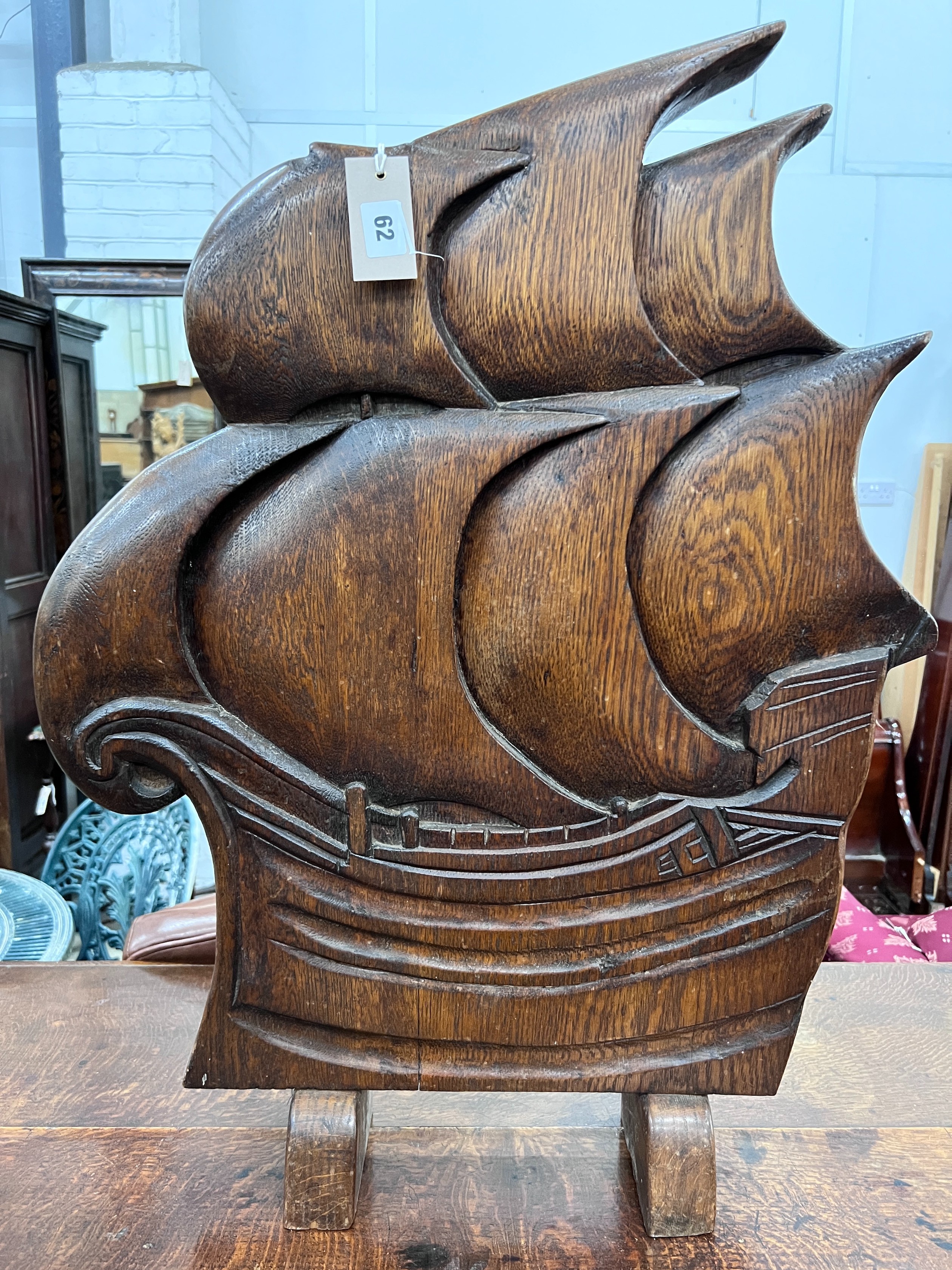 An Art Deco style carved oak firescreen in the shape of a ship, width 57cm, height 74cm *Please note the sale commences at 9am.